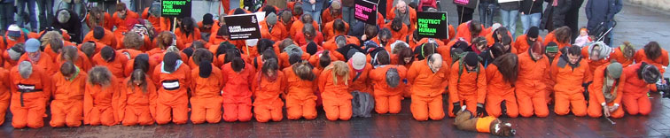 Demonstrators recreating the Guantanamo Bay submission position in the heart of Edinburgh