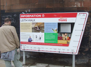 A Leither studies the information board on Leith Walk
