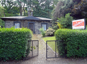 View of the single story house in Royal Terrace Gardens with To Let sign