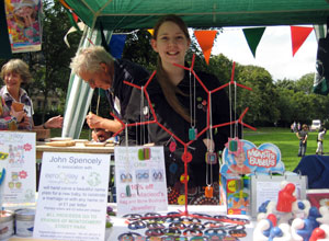 Claire MacLeod smiles behind her earrings at the Eero & Riley stall