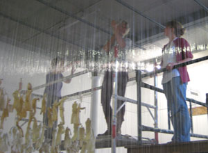 Jane Frere on the scaffolding with Pippa Spencer Nairn, media consultant, seen through the shimmering nylon wires