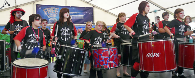 Duncan Place Resource Centre, Leith's Pulse of the Place drummers in black and red teeshirts  drumming