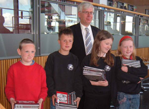 Four children aged around 10,  holding copies of the Burma Book with Mark Lazarowicz, at Ocean Terminall