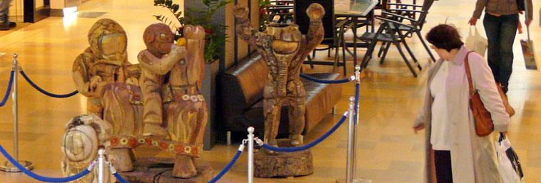 View of the face of the Circe sculpture, with the  red rim  of the foyer's cupola behind