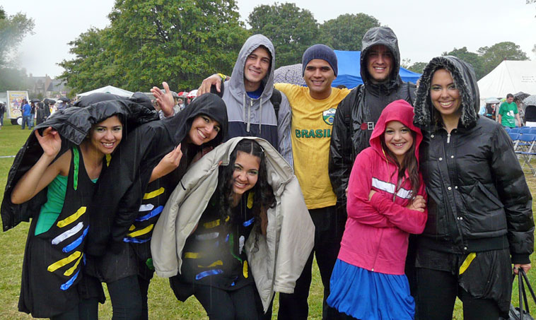 Young smiling Brasilians with waterproofs over their heads