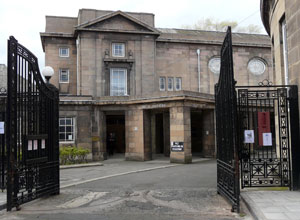 View of Thomas Morton Hall through the black painted iron gates.