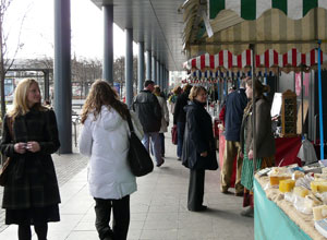 View of shoppers exploring stalls in front of Ocean Terminal looking towards Gt Junction St