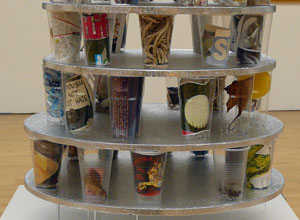 Three rows of plastic cups with modern artifacts, tiered echoing "La Tour Visuelle"