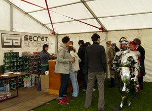 The armoured knight and others queuing in the beer tent