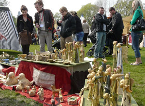 People looking at statuettes in the foreground
