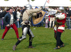 Two helmeted men sword to sword
