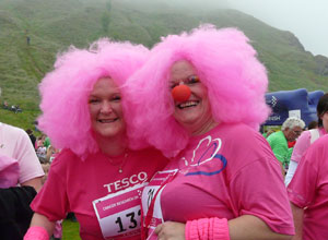 Two women with candy floss pink clown wigs