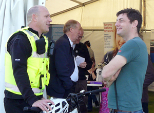 The two men are relaxed and smiling with Malcolm Chisholm MSP in the background