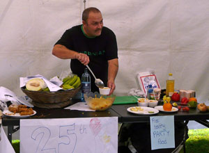 Man in black tee shirt serving pasta