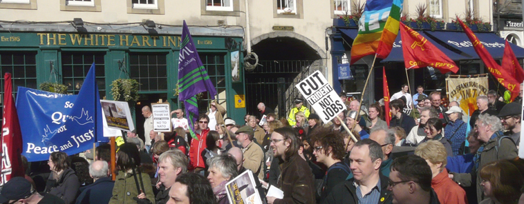People standing and listening to speeches with The White Hart Inn in the background