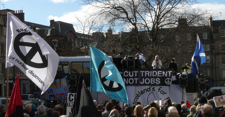 CND flags and listeners in the foreground looking towards Leslie Riddoch speaking in the distance