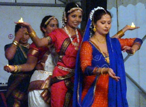 Four dancers in line with candles