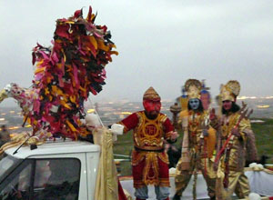 Lorry with a multi coloured eagle on the cabin and three men dressed as Lord Rama and his allies