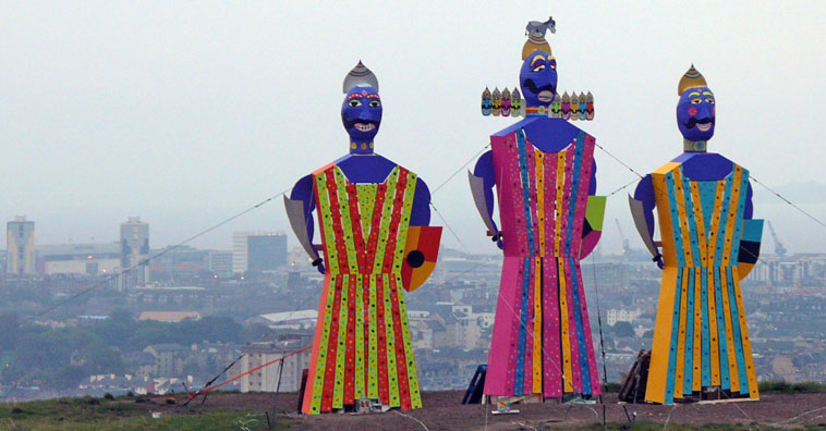 Effigies of Ravana, centre, with his brother Kumbhakarna and son Meghanad, atop Calton Hill, with Leith in the background