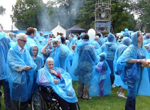 Spectators in blue disposable  ponchos