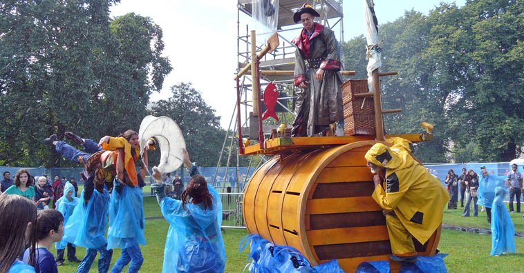 Pirate stands aboard the fisherman's boat as the fisherman cowers behind it and the traveler is carried away