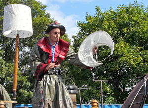 Man in souwester holidng crescent moon on a stick