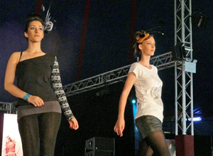 Two women in black and white casual wear walking down the catwalk