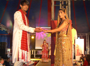 Bridal couple holding hands at the front of the catwalk