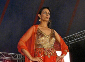 Woman posing in a gold  and red bridal outfit