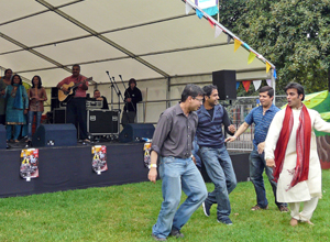 Four men doancing in front of the stage