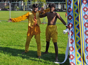 Two young men in yellow costumes smiling for the camera with their arms held out
