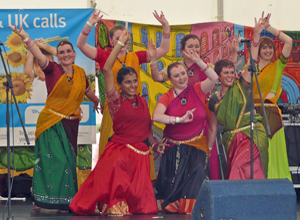 The seven dancers strike a pose at the end of their performance