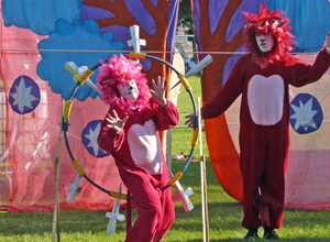 Red and pink lion climbing through  a circle of knives