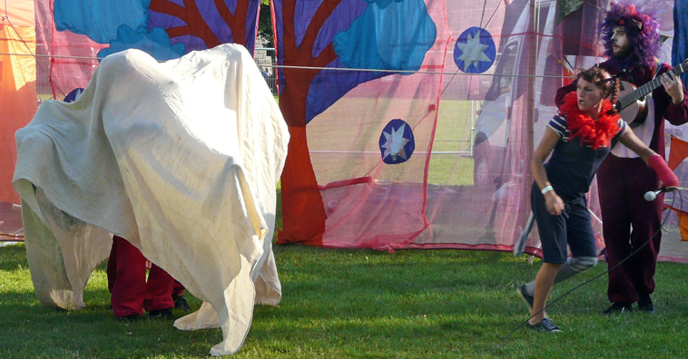 Lions insidea muslin sheet  impersonating an elephant as woman runs away