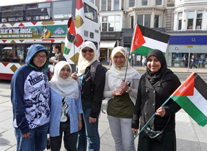 Young women in head scarves with Palestinian flags