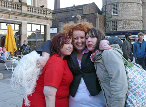 Adele Conn with the  empty balloon net in her hands,  hugging the two cellophane girls