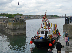The Queen's barge arriving in Newhaven Harbour with Granton Village in the background