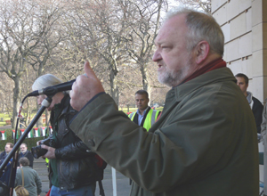 Rev Iain Galloway speaking in a khaki raincoat