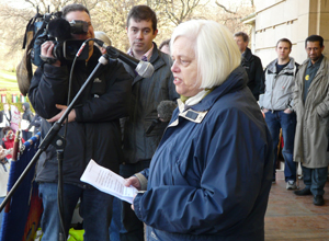 Jenny Dawe speaking in blue anorak with white scarf