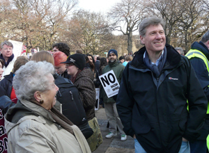 Phyllis Herriot and Kenny MacAskill in the crowd with winter trees in the background