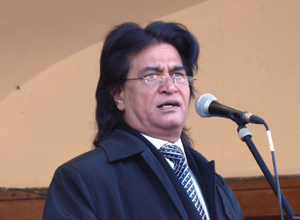 Shami Khan speaking in blue rain coat