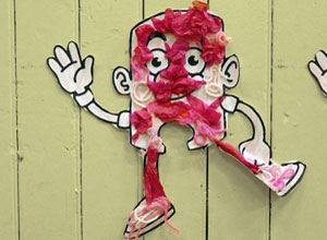 Waving figure decorated with pink wool and tissue paper