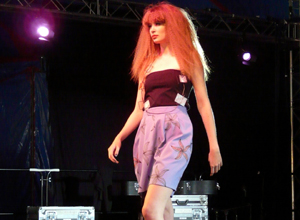 Woman in shoulderless plum top with lilac coloured shorts