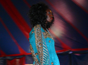 Woman in tourqoise blue dress with silver trim