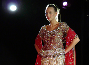 Bridal couple holding hands at the front of the catwalk