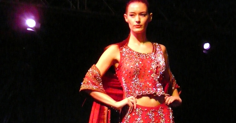 Woman in red two piece outfit with shawl