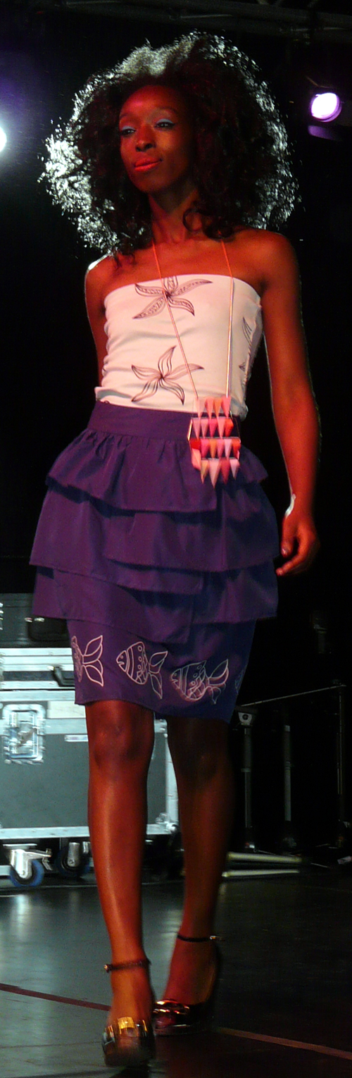white shoulderless top with purple layered skirt