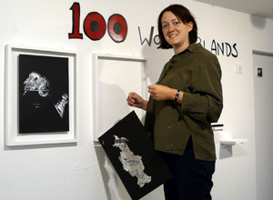 Alice Bethune Spicer in an olive shirt, hanging a drawing