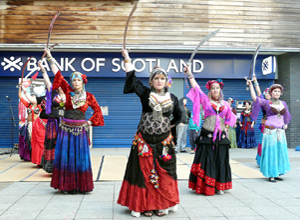 Five women in ATS costume with swords raised