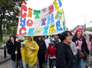 Cheering young people with banner in coloured letters reading CITADEL YOUTH CENTRE